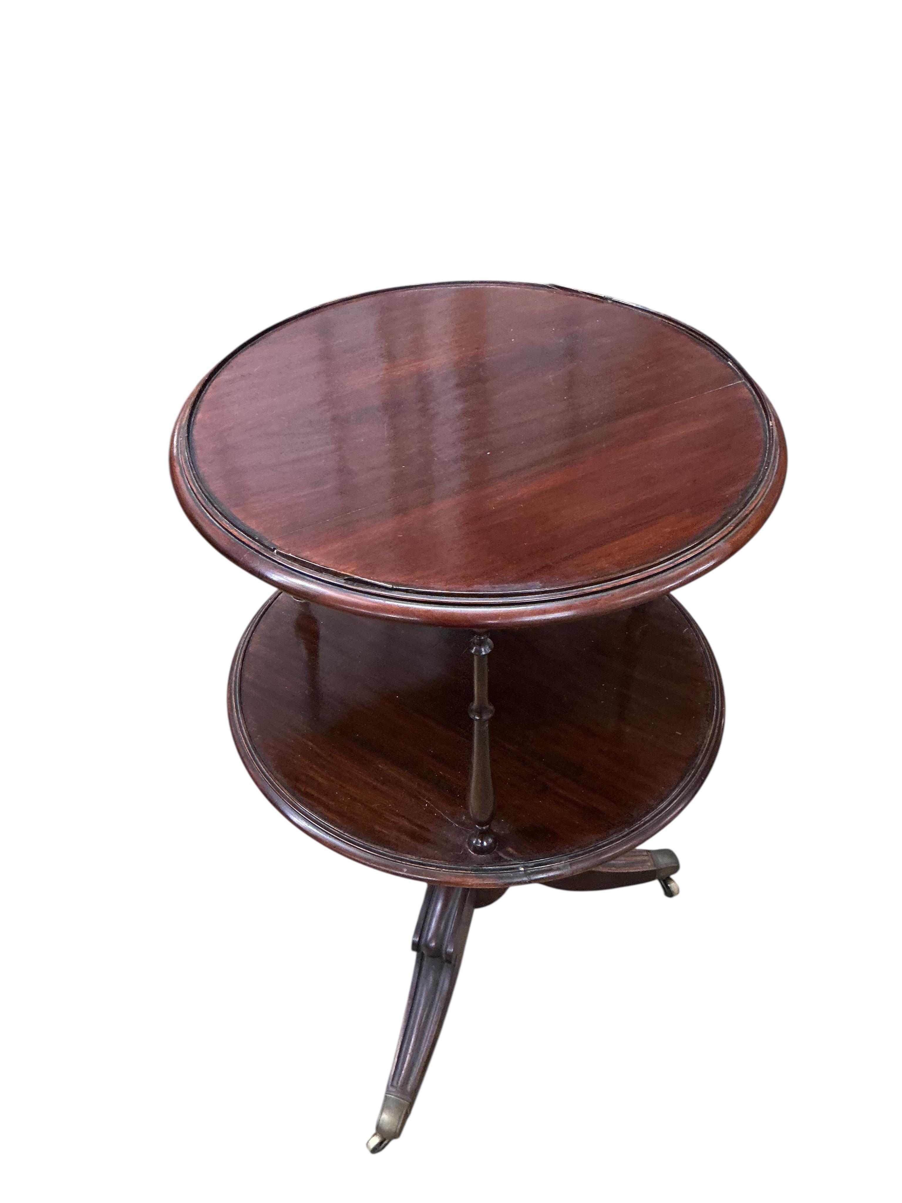 An early 20th century circular mahogany two tier whatnot, diameter 60cm, height 98cm
